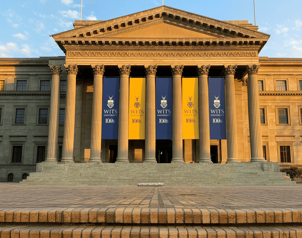 A university building with its banners hung between the columns
