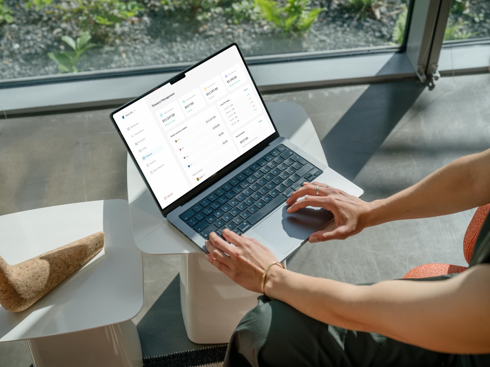 Business owner reviewing treasury balances on a laptop